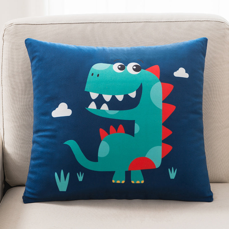 Blue pillow with a dinosaur design on a beige couch