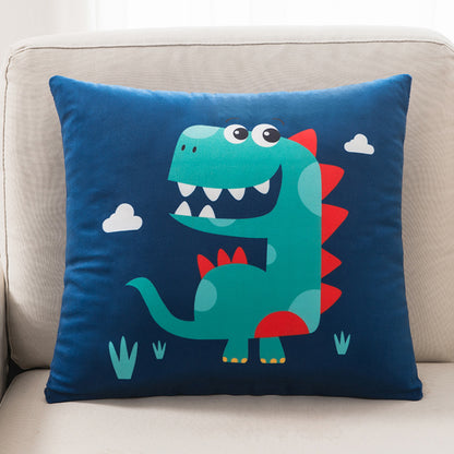 Blue pillow with a dinosaur design on a beige couch