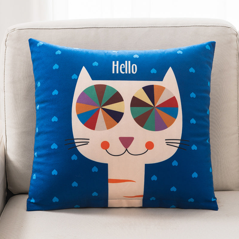 Decorative pillow with a colorful cat design and 'Hello' text on a blue background, placed on a beige couch.