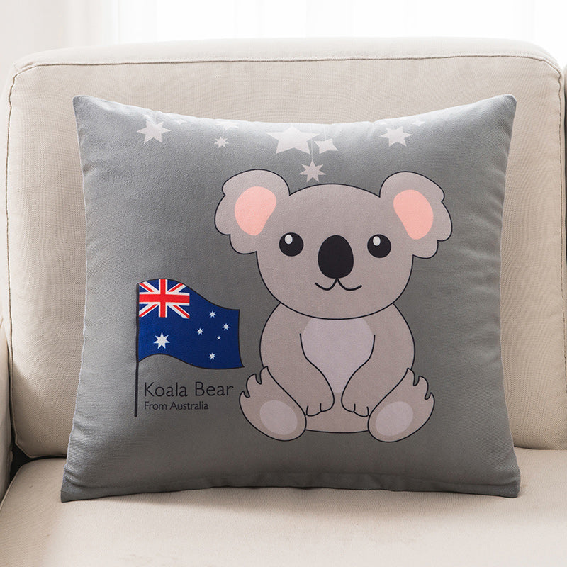 Gray pillow with a koala bear design and Australian flag on a beige couch.