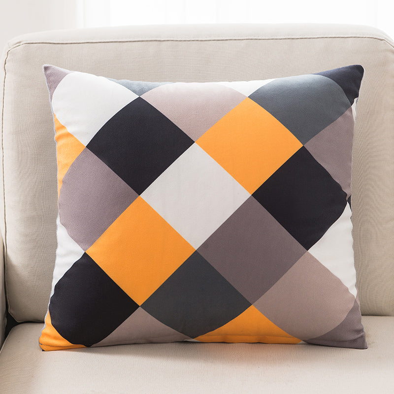 Decorative pillow with geometric pattern on a beige sofa